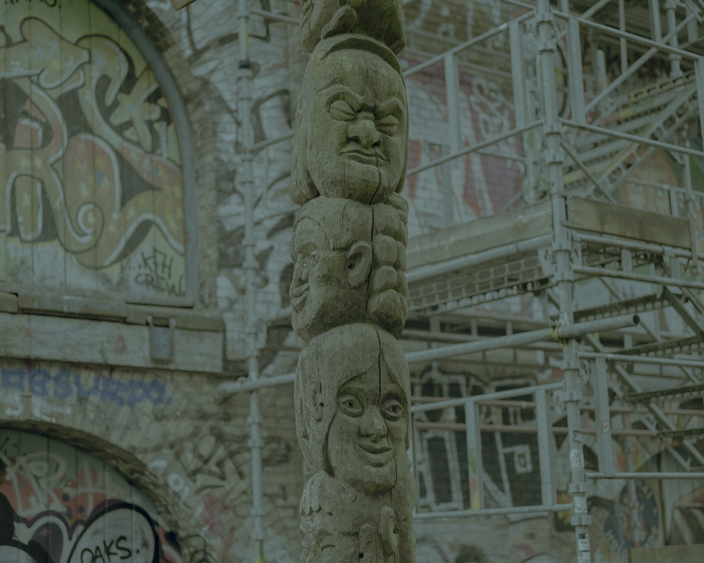 The wooden totem-style column is part of the entrance gate to Christiania.