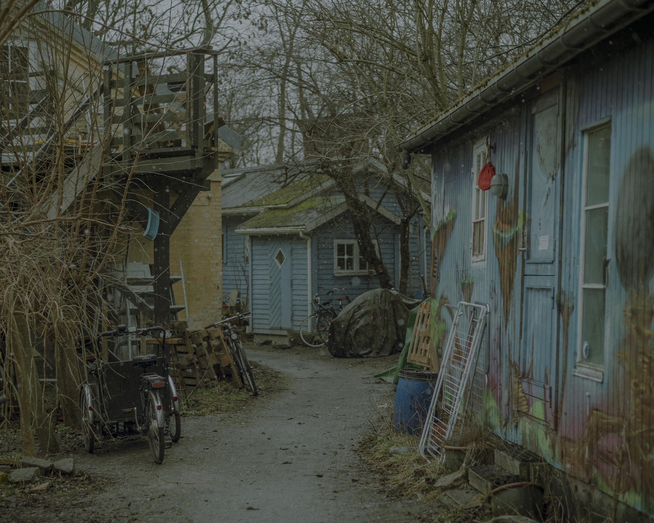 Members of Christiania share small wooden wagons and also sturdy houses built as part of Copenhagen's defence system.