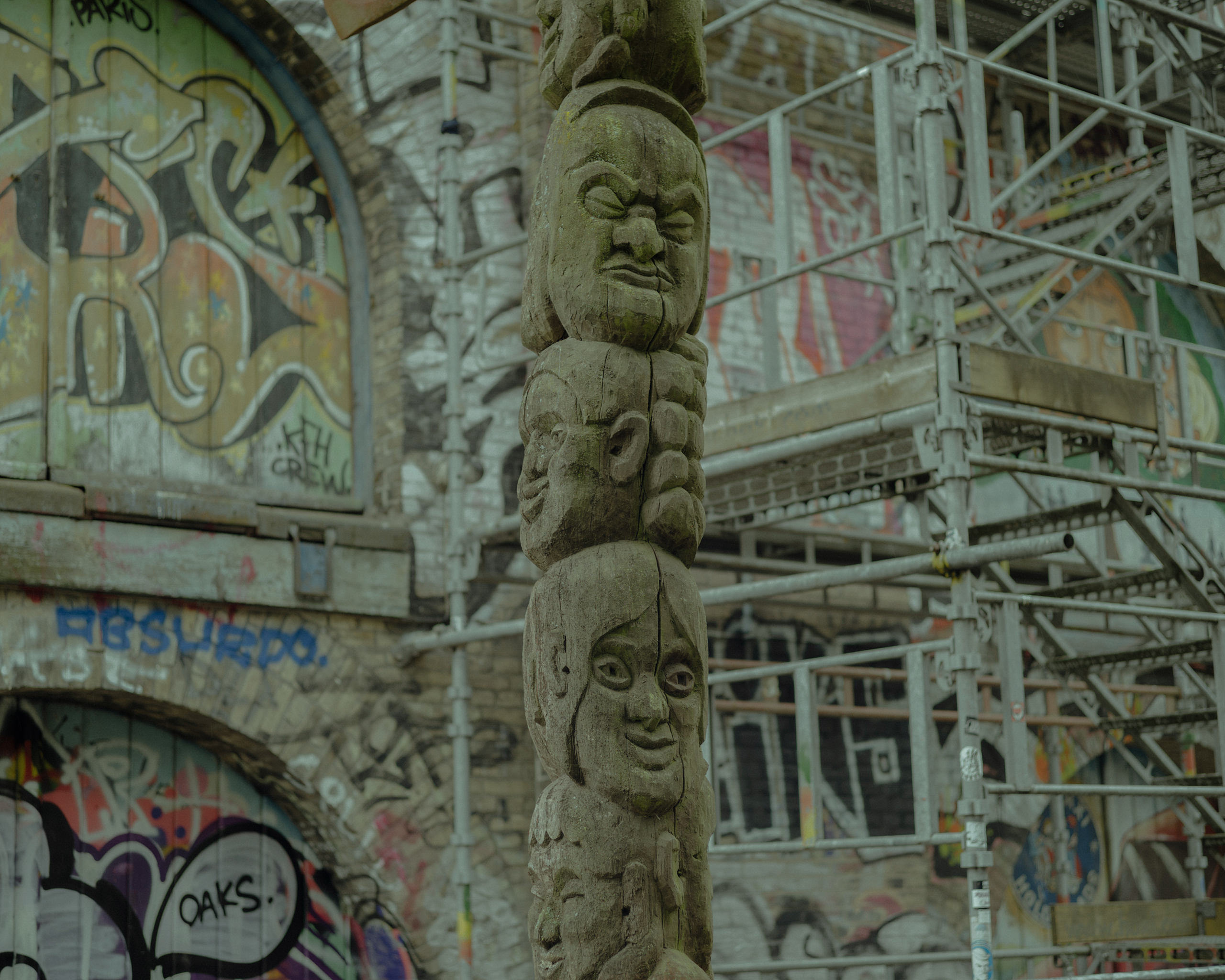 The wooden totem-style column is part of the entrance gate to Christiania.